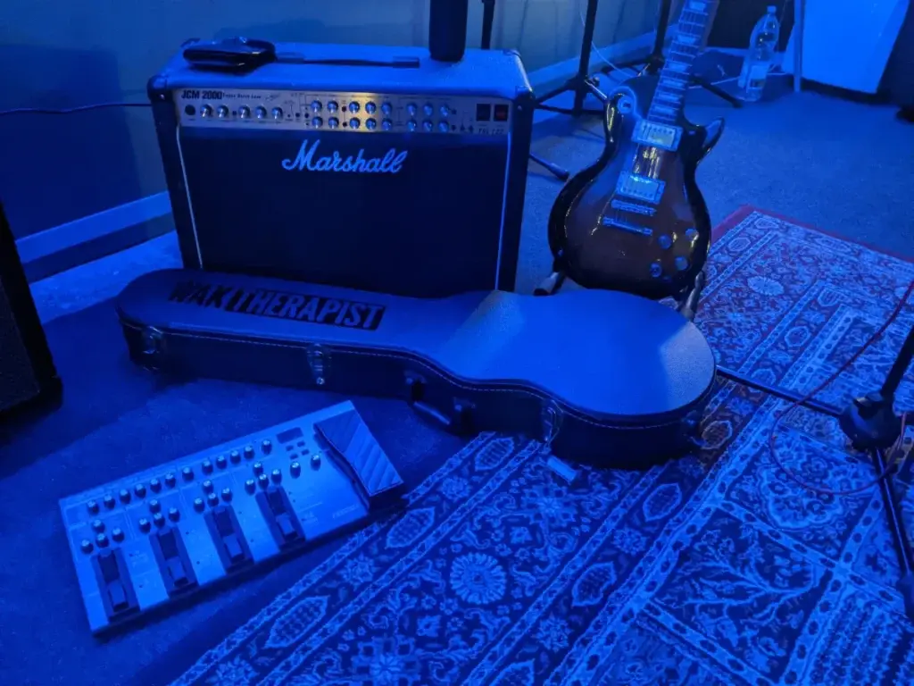 Guitar equipment lying on the floor in blue lighting